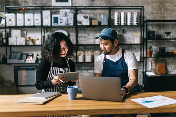 Small business owners working behind cafe counter