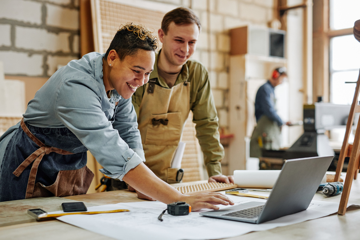 Employees working in a small business carpenter shop