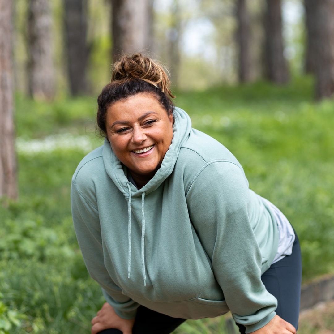 A woman resting while exercising outside